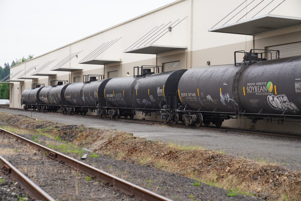 Rail-served warehouse with freight railcars for bulk logistics and distribution at Wymore Transfer.